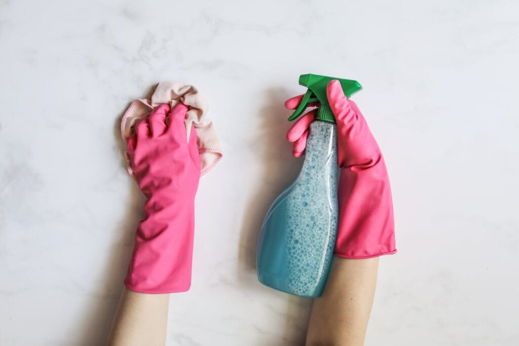 A Person Cleaning Using Cleaning Products